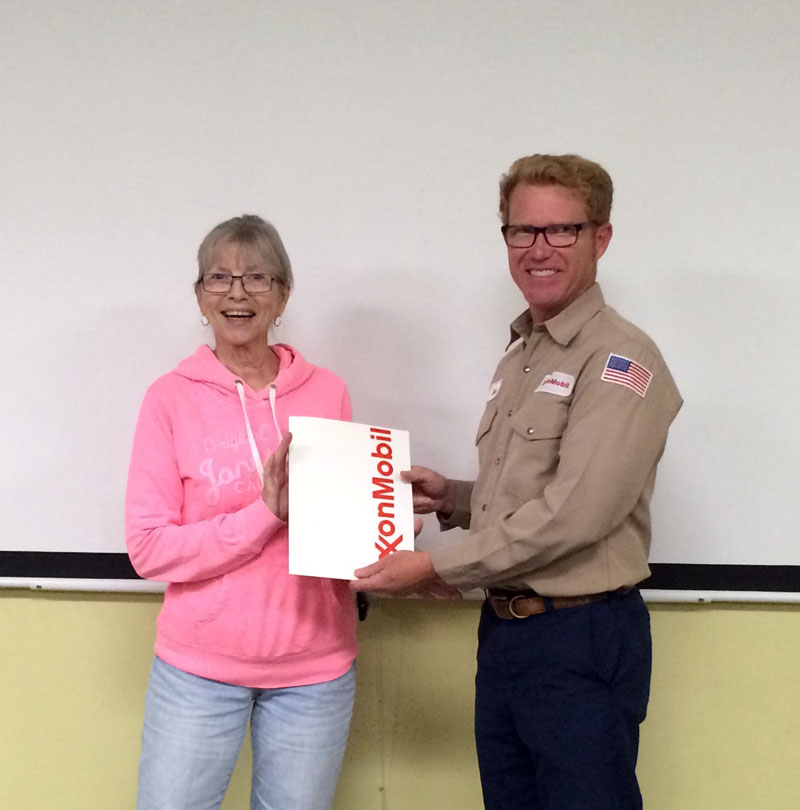 FOMM President Suzan Hubert accepts check from ExxonMobil, presented by Steve Giffen